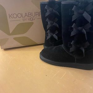 Kookaburra boots by UGG.  Black boots with 3 bows down the side.
